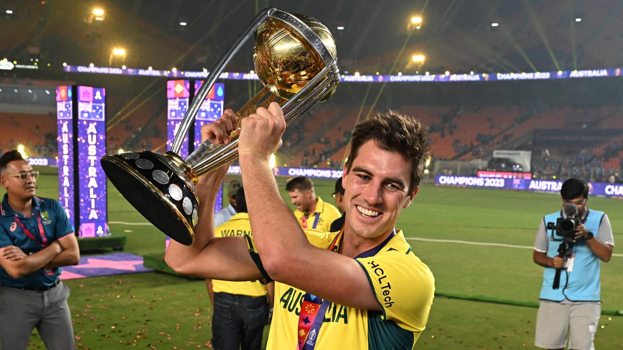 Australia's captain Pat Cummins poses with the trophy.