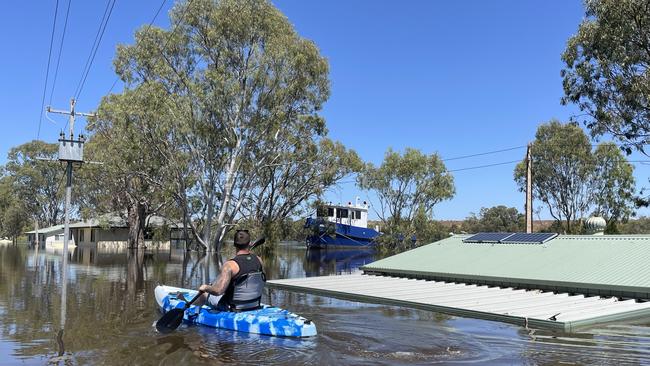 Joel Eglinton canoes around his families Murray River shacks to document the extent of flooding from the rising Murray River waters at Swan Reach, SA. Picture: Joel Eglinton