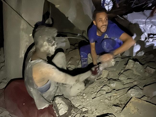 A man shouts as he pulls a survivor from the rubble of a building following an Israeli strike near the Kamal Adwan hospital in Beit Lahia, in the northern Gaza Strip. Picture: AFP