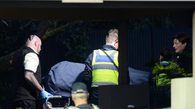 Police help remove a body from the scene of the 2017 Brighton siege.