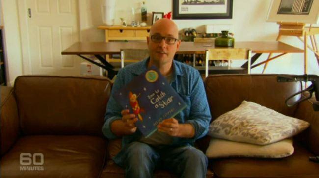 Dr Ian Davis reads to his unborn son. Courtesy 60 Minutes.