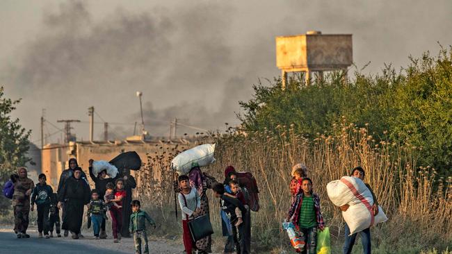 Civilians flee from Ras al-Ain during the onslaught. Picture; AFP.