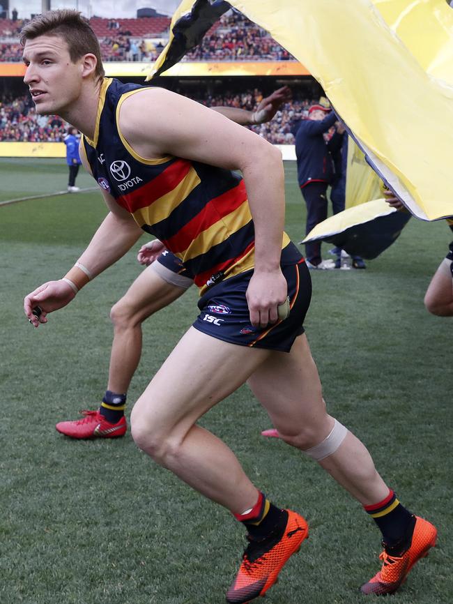 Josh Jenkins runs through the Crows banner during the 2018 season. Picture SARAH REED