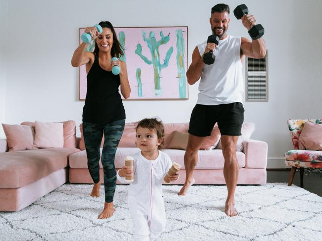 Sam Wood, his wife Snezana and his daughter Willow, working out at home. Picture: Supplied