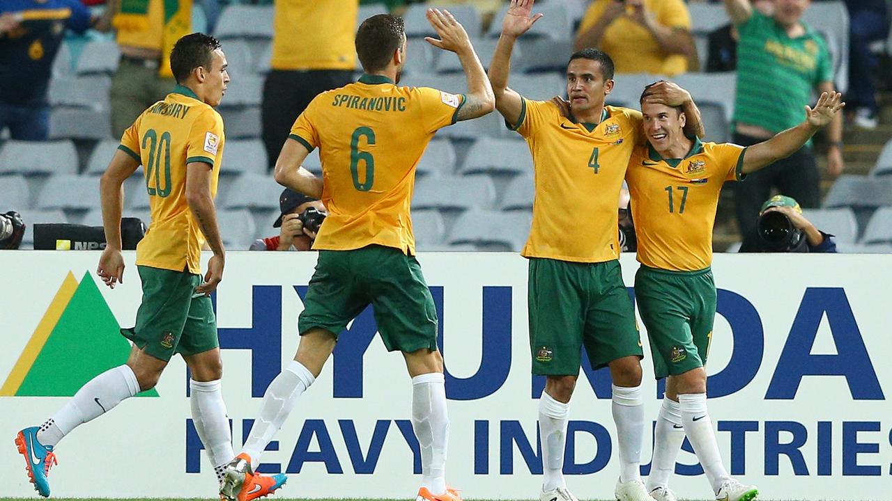 SYDNEY, AUSTRALIA - JANUARY 13: Matt McKay of the Socceroos is congratulated by team mates after scoring a goal during the 2015 Asian Cup match between Oman and Australia at ANZ Stadium on January 13, 2015 in Sydney, Australia. (Photo by Cameron Spencer/Getty Images)