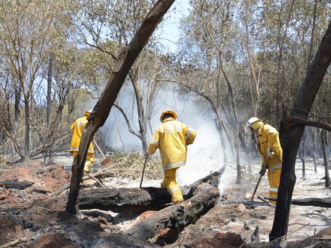 Rural firefighters worked through the day to dampen hot spots and prevent a flare up at the Pechey bushfire, north of Toowoomba, November 14.