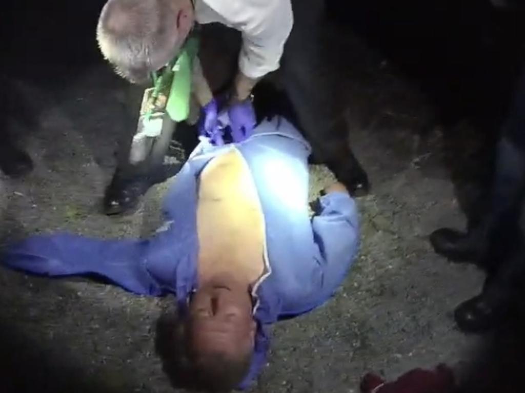 Andrew Cobby laying on the ground after being found by police.