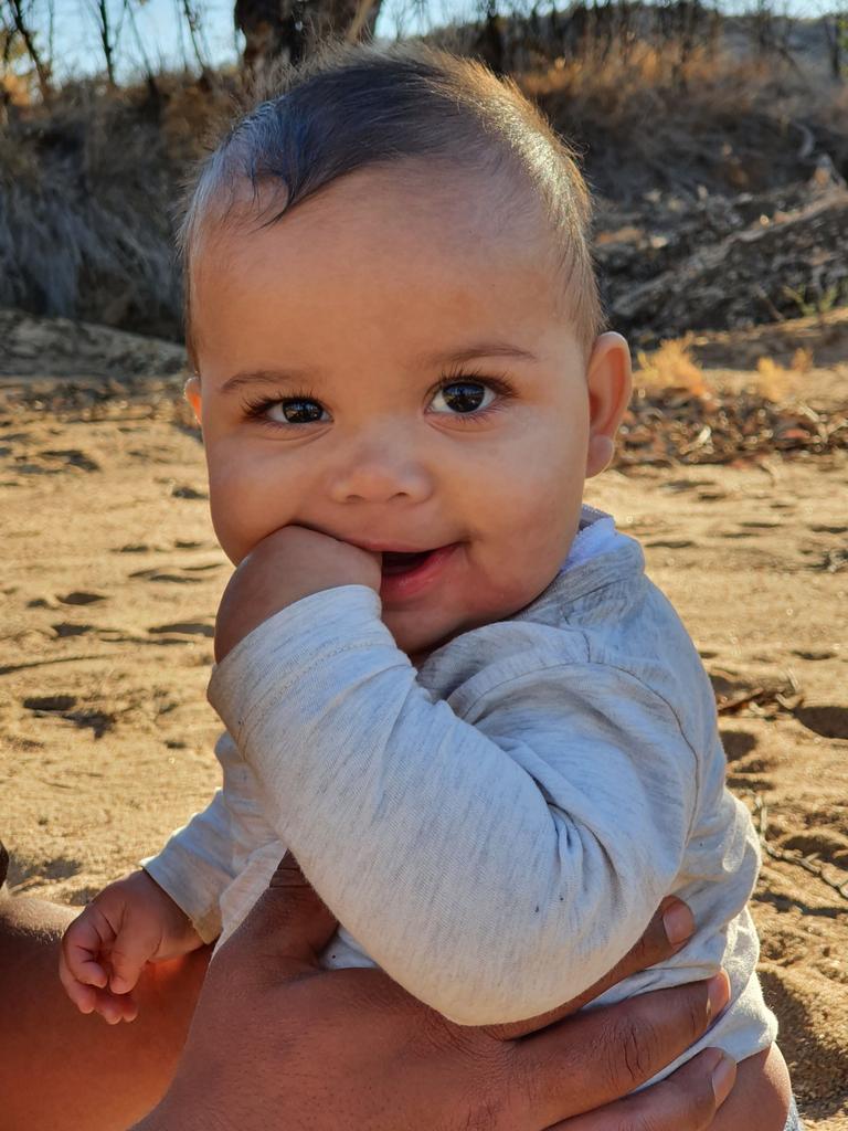 Gussy being held by dad during playtime in Roe Creek. Picture: Cherisse Buzzacott