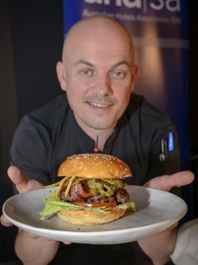 Luke Brabin, executive chef at Feathers pub, with his wagyu beef burger, which won best pub burger in South Australia