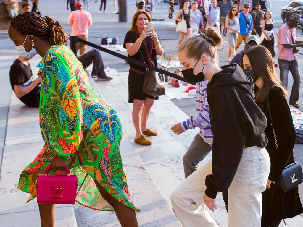 This woman in the background wasn’t going to miss her happy snap moment. Picture: AbacaPress / SplashNews.com / Media Mode