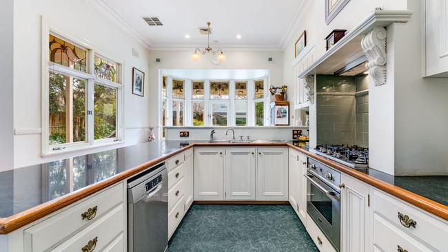 A modern open-plan kitchen with a walk-in pantry.