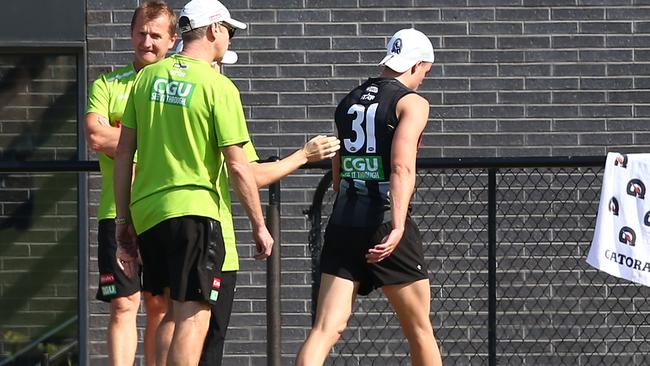 Jackson Ramsay leaves the field after injuring his knee at training. Picture: Scott Barbour/Getty Images