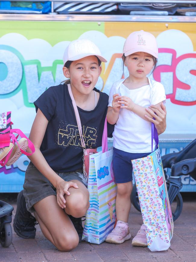 Evie Pattermore and Scarlett Lai enjoying day one of the Royal Darwin Show. Picture: Glenn Campbell