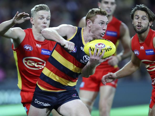 28/04/18 - AFL - Round 6 - Adelaide Crows v Gold Coast Suns at the Adelaide Oval. Tom Lynch gets his handpass out from Max Spencer. Picture SARAH REED