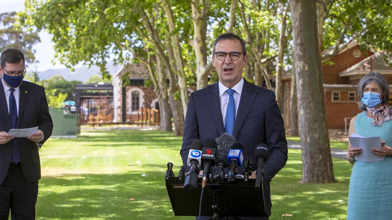Premier Steven Marshall speaks to media with Education Minister John Gardner (left) and Professor Nicola Spurrier (right) at a press conference in Adelaide on Friday. Picture: NCA NewsWire / Emma Brasier