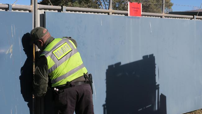 An Alice Springs Town Council ranger shuts the gate at the Alice Springs Animal Shelter. Picture: Gera Kazakov.