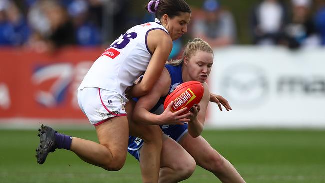 Daria Bannister of the Kangaroos is tackled by Matilda Sergeant of the Dockers during the round 9 AFLW match between the North Melbourne Kangaroos and the Fremantle Dockers at Arden Street Ground on March 27, 2021 in Melbourne, Australia. (Photo by Robert Cianflone/Getty Images)