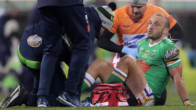 Josh Hodgson receives treatment on a knee injury during Saturday night’s clash against Melbourne Storm. The Raiders hooker was ruled out for the season on Sunday. Picture: Getty Images