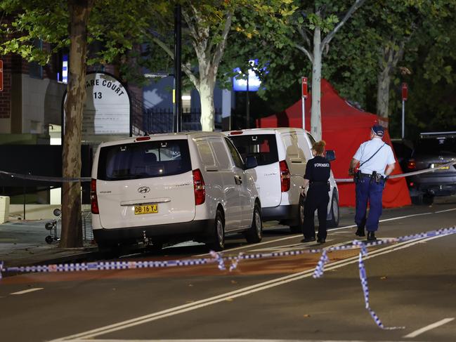 A tent is set up around the body of the teen outside Blacktown Police Station on Friday night. Picture: Richard Dobson