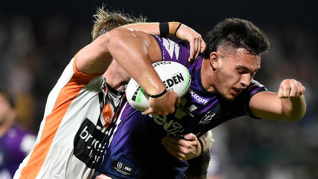 SUNSHINE COAST, AUSTRALIA - SEPTEMBER 19: Tino Faasuamaleaui of the Storm is tackled during the round 19 NRL match between the Melbourne Storm and the Wests Tigers at Sunshine Coast Stadium on September 19, 2020 in Sunshine Coast, Australia. (Photo by Matt Roberts/Getty Images)