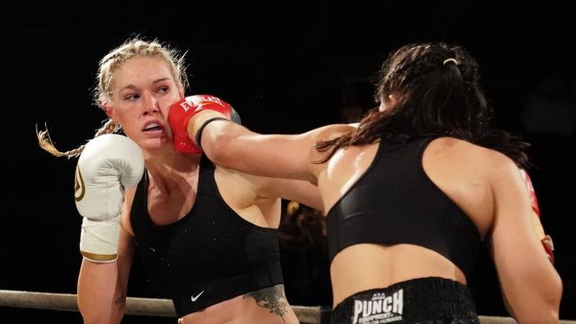 Tayla Harris wears a blow from Janay Harding during their Super Welterweight Title bout.