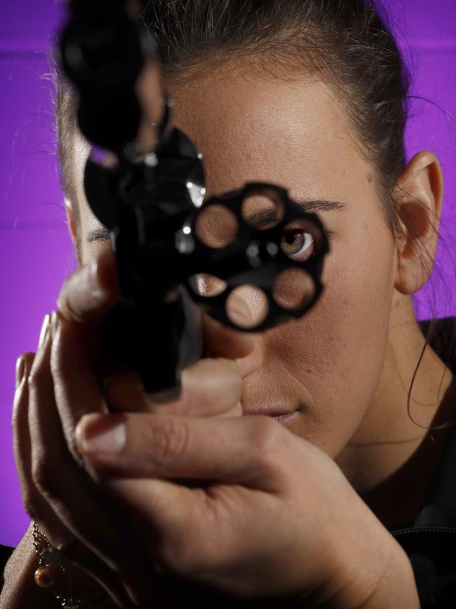 Ballistics support officer Elise Castronini looks through the barrel of a 44 Magnum Smith and Wesson, which is one of 9,500 guns in the weapons library at the Sydney Police Centre. Picture: Toby Zerna