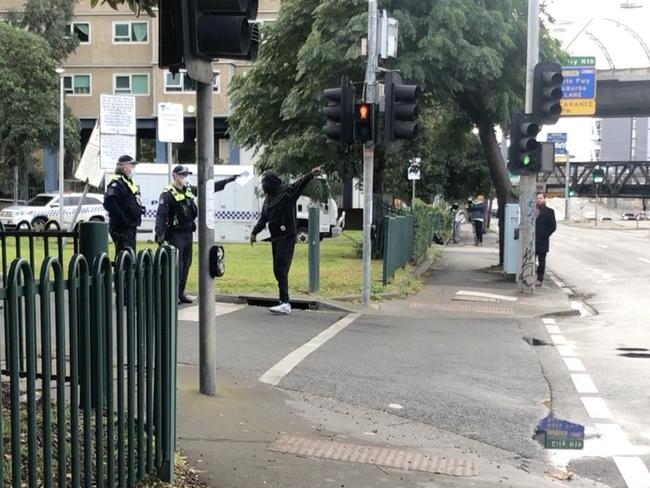 An angry youth is escorted from Melbourne's locked down towers. Picture: Remy Varga