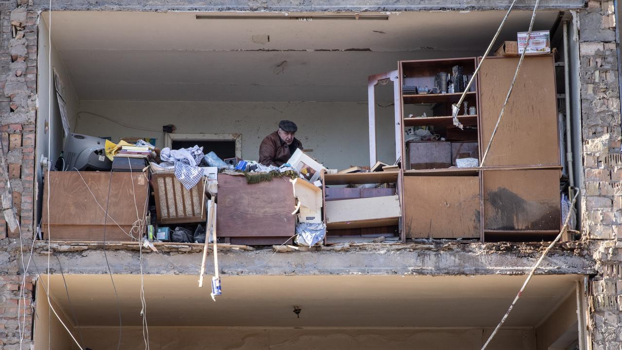 A man looks through his belongings in his destroyed apartment at a residential apartment complex that was heavily damaged by a Russian attack in Kyiv. Picture: Chris McGrath/Getty Images