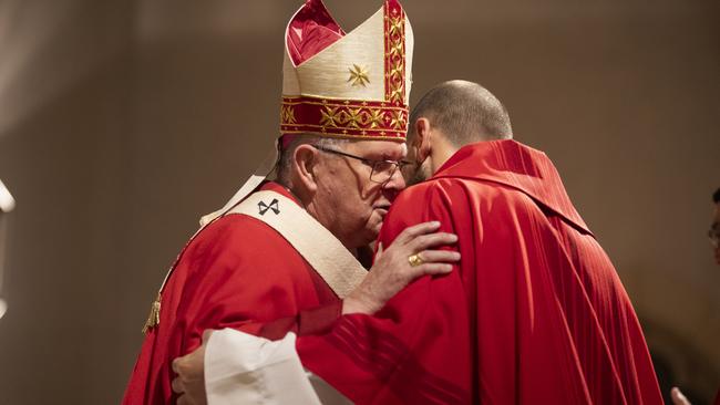 Bishop Coleridge embraces Falzon. Picture: Natalie Grono