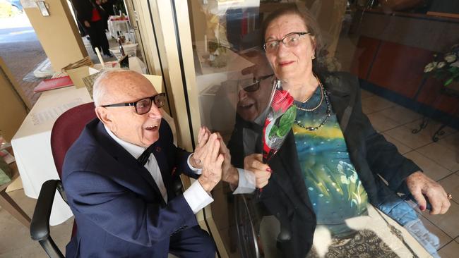 Giuseppe, 90, and Tina, 95, celebrate their 70th wedding anniversary separated by glass at a Sydney aged-care home. Picture: Tait Schmaal