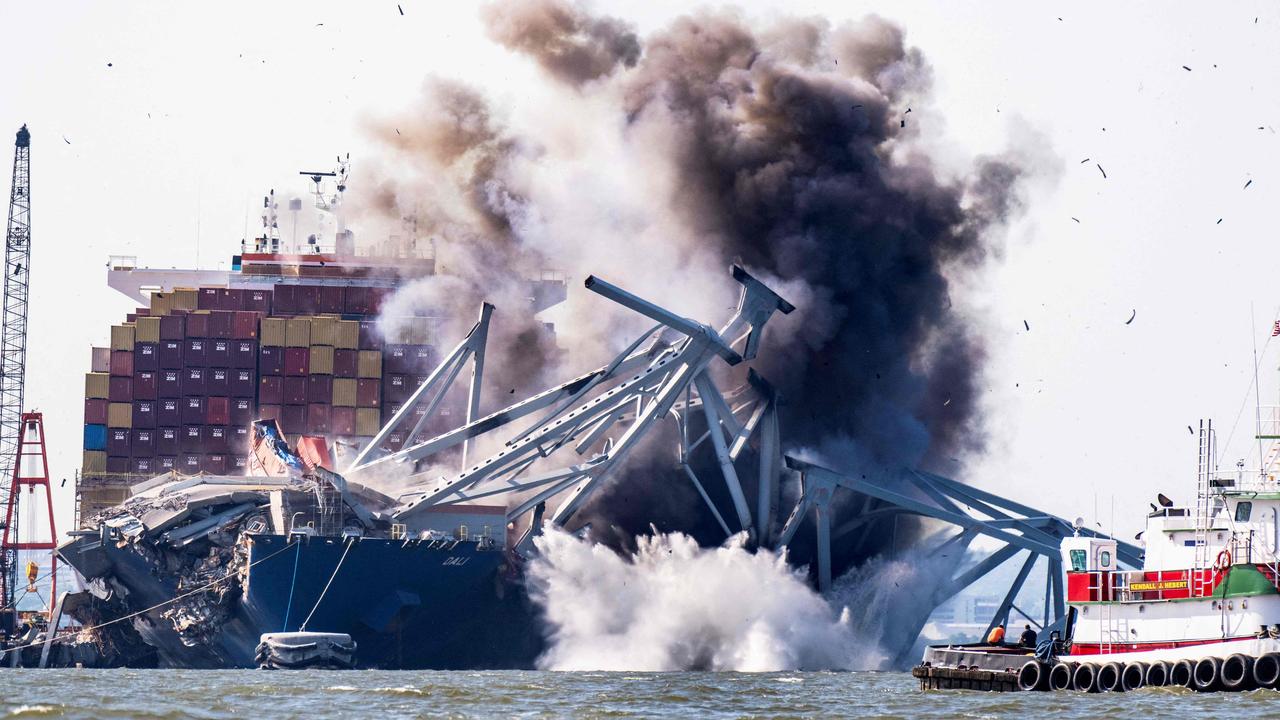 Demolition experts used explosives to remove a part of the bridge and free a cargo ship that had been trapped since March. Picture: Roberto Schmidt / AFP