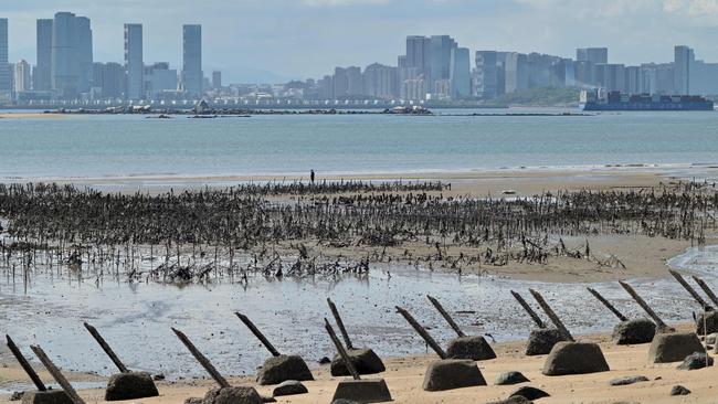 The Xiamen city skyline on the Chinese mainland is seen past anti-landing spikes placed along the coast of Lieyu islet on Taiwan's Kinmen islands, which lie just 3.2km from the mainland China coast.