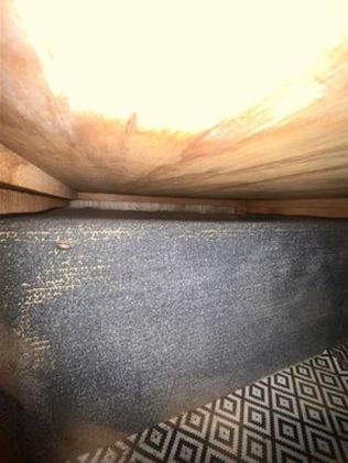 Fire damage on the carpet near the cupboard. Picture: Supplied