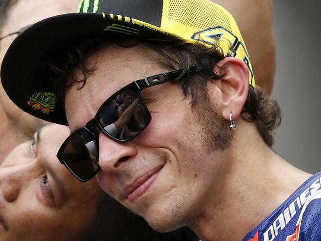 Yamaha MotoGP rider Valentino Rossi of Italy takes photos with fans after the free practice session of the Malaysian Motorcycle Grand Prix at Sepang International Circuit near Kuala Lumpur, Malaysia, October 23, 2015. REUTERS/Olivia Harris