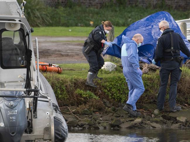 Police at the scene of the grim discovery in the Maribyrnong River at Flemington. Picture: Tony Gough