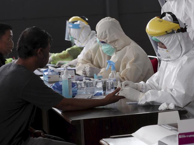 Indonesians have their blood samples taken at a coronavirus rapid test site in Tangerang, Indonesia, Tuesday, April 21, 2020. Indonesian President Joko Widodo has banned people in the world's most populous Muslim-majority nation from returning to their hometowns to celebrate Eid al-Fitr holiday that marks the end of the holy fasting month of Ramadan, amid warnings from health experts that the country could face an explosion of coronavirus cases unless the government takes stricter measures. (AP Photo/Tatan Syuflana)
