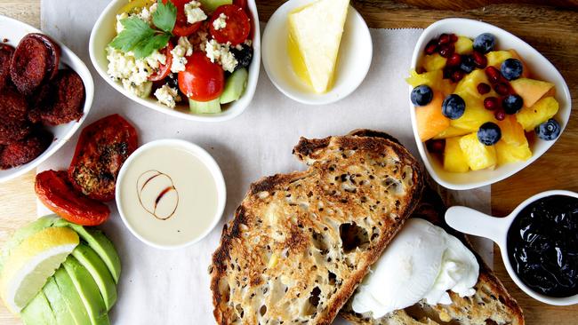 Hakan's Sultan's Big Breakfast with poached eggs, tahinni &amp; pekmez, sour cherry jam, cokelek cheese, nigella seeds, tomato, cucumber, avocado, fruit, lemon, toast and Anatolian sausage.