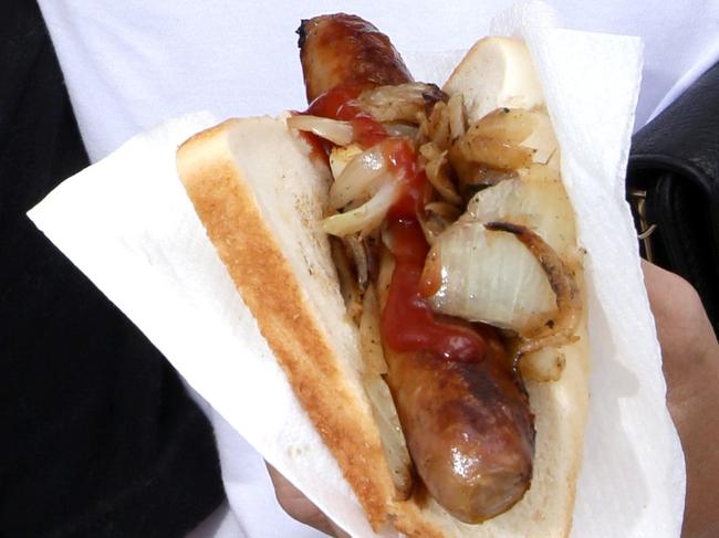 Bunnings Stores throughout Queensland raised $88000 on Australia Day sausage sizzles, Sausage sizzle at Brendale store. Jye and Carley Bennion (warner) with a sausage,