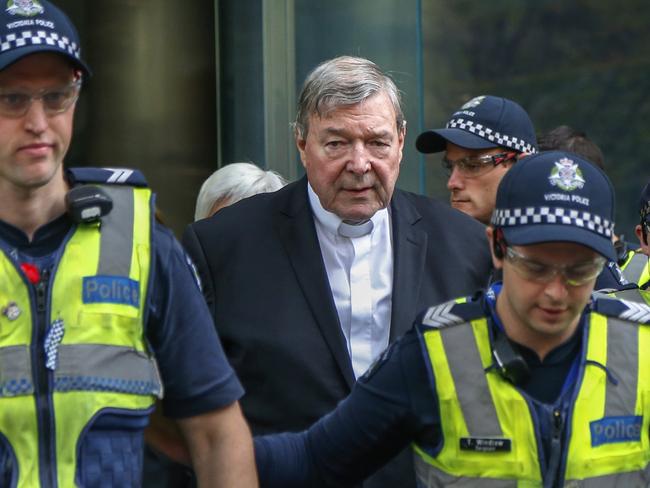 FILE - In this May 2, 2018, file photo, Cardinal George Pell, the most senior Catholic cleric to face sex charges, leaves court in Melbourne, Australia. Pell was sentenced in an Australian court on Wednesday, March 13, 2019 to 6 years in prison for molesting two choirboys in a Melbourne cathedral more than 20 years ago.  (AP Photo/Asanka Brendon Ratnayake, File)