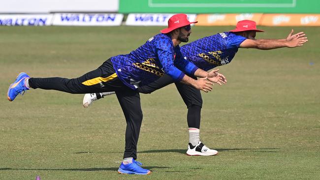 Afghan cricketer Mohammad Nabi, left, stretches before a match against Bangladesh at the Zahur Ahmed Chowdhury Stadium in Chittagong last month. Picture: AFP