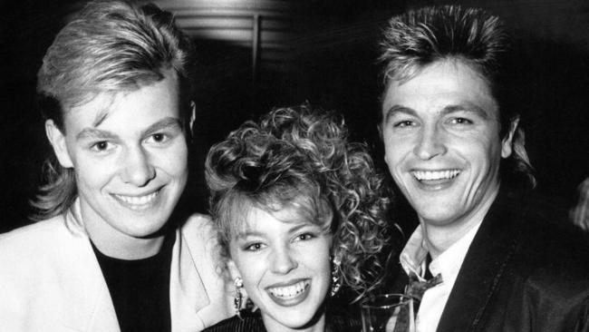 July, 1987: Singer and actress, Kylie Minogue (centre), with fellow actor, Jason Donovan (L), both from 'Neighbours', with Peter O'Brien, from 'The Flying Doctors'.