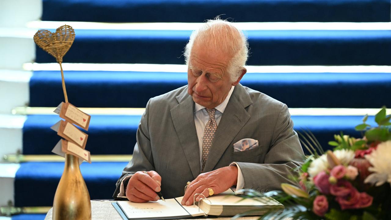 The King signs a book of condolence for the victims of the Southport mass stabbing. Picture: AFP