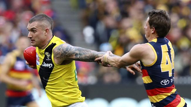 Matt Crouch latches on to Dustin Martin at the MCG. Picture: Sarah Reed