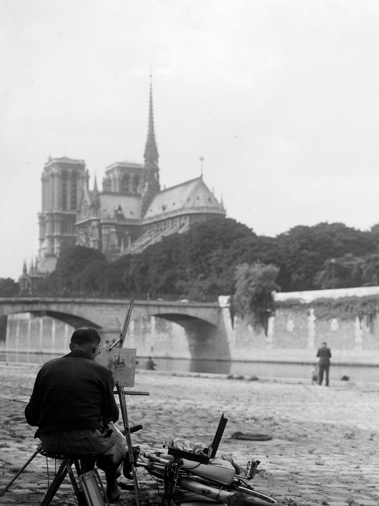 July 01, 1945: A man painting Notre-Dame Cathedral. Picture: AFP 