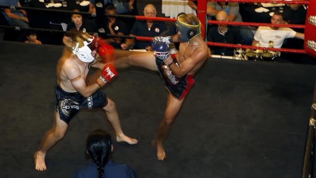 ACTION-PACKED: Brayden Brown (Courage Training Centre) is kicked by Jean Luc Karpinski (Fusion Southside) at the Path to Elite fight night, held at the Cairns Colonial Club on Saturday. Picture: ANNA ROGERS