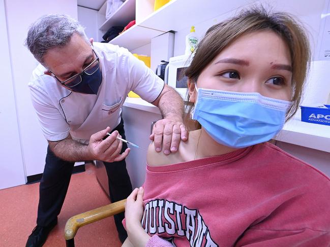 06/08/2021:Emily Ngo 21 receives a walk in AstraZeneca vaccine injection from manager George James,  at a chemist pharmacy in Fortitude Valley, Brisbane. Lyndon Mechielsen / The Australian