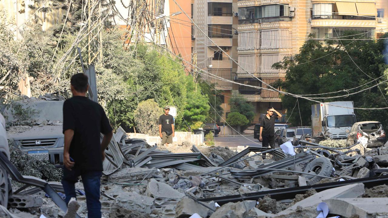 People inspect the devastation in the Hadath district of Beirut's southern suburbs in the aftermath of intense overnight Israeli airstrikes. Picture: AFP