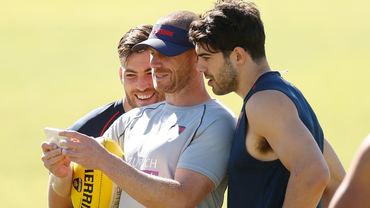 Goodwin shares a lighter moment with Jack Viney and Christian Petracca. Picture: AFL Photos via Getty Images