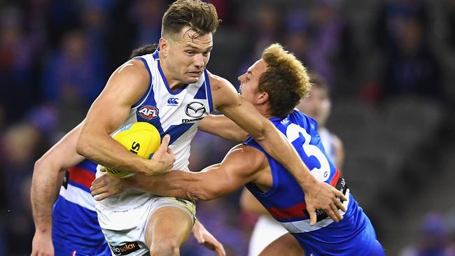 Shaun Higgins fends off Mitch Wallis late in the game ... both men had a big say in the final minute. Pic: Getty Images