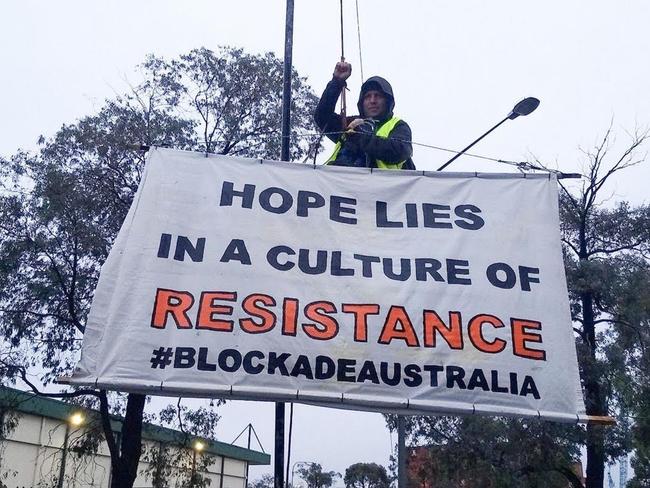 Brad has climbed onto a pole blocking the operations in and out of the Port of Melbourne. Supplied